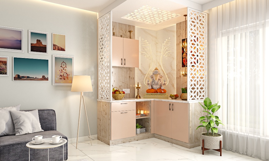 Puja unit design in L-shaped with blush pink and intricate jaali work on the roof and partitions